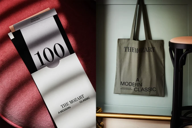 Promotional image featuring a voucher and tote bag branded with 'The Mozart Classic,' staged against a muted background for elegant advertising.