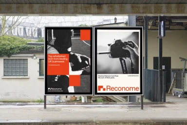 Two advertising posters for Reconome displayed outdoors at a platform station with architectural background