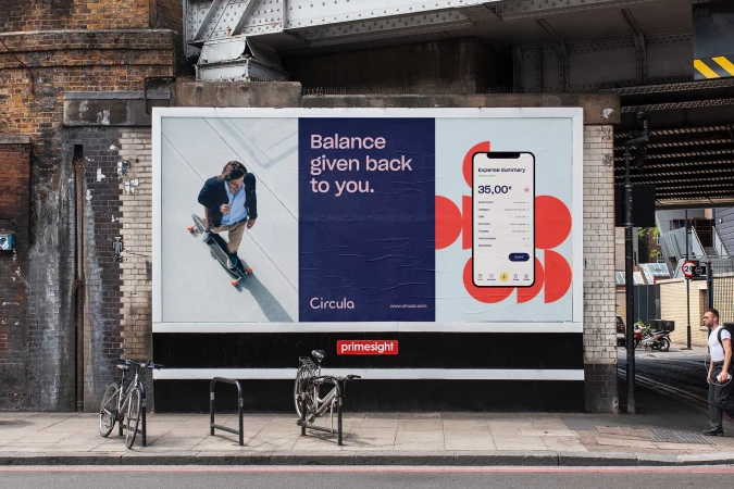 Outdoor billboard advertisement in urban setting featuring a man on a skateboard and a mobile phone screen with expense summary.