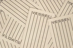 Scattered cream paper slips featuring black vertical line patterns and Vessel Floats typography branding.