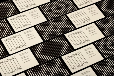 Overhead flat lay of multiple Vessel Floats business cards featuring minimalist typography and black and white striped patterns.