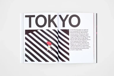 Open magazine spread on white surface featuring bold Tokyo typography and an editorial page design for Christies Brand Identity