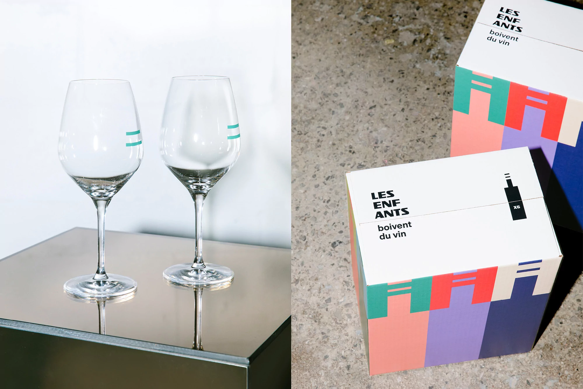 Two elegant wine glasses with teal accents sit on a sleek table beside gift boxes with bold geometric designs and modern typography.