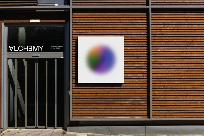 Exterior shot of a modern building with wooden siding and an abstract art piece next to the doorway entrance.