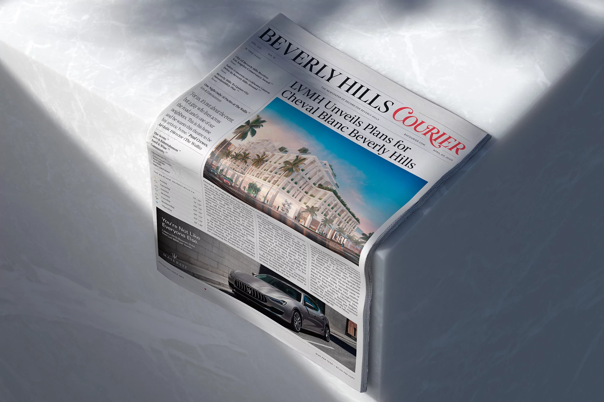 LVMH Cheval Blanc Beverly Hills plans featured on newspaper in indoor setting, showcasing luxury architecture and automotive design.