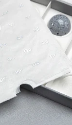 Close up product packaging with frosted overlay showing chemical symbols for CF18 Chocolatier brand identity.