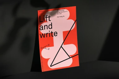 A bold red and pink graphic poster with black typography reading Lift and write, displayed against a dark textured background.