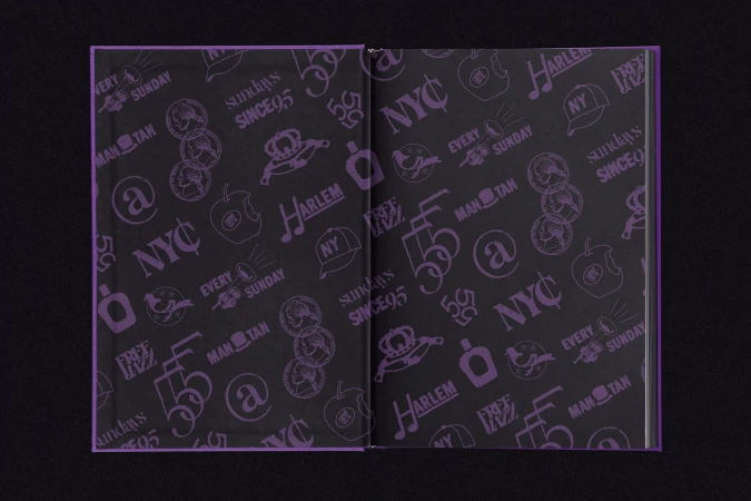 Open book with purple cover and dark grey patterned interior pages featuring New York City, Harlem, and Manhattan motifs.
