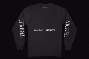 Black long-sleeve t-shirt featuring white typography reading TRIPLE on the left sleeve, NICKEL on the right, and Crown Royal branding on the chest.