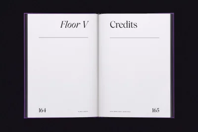 Open book layout with minimalist typography showing Floor V and Credits headings on white pages