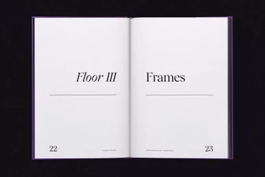 Open book page layout displaying Floor III Frames with typography set against a black background