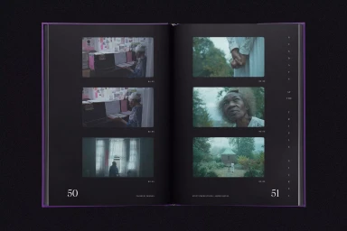 An open purple-bound book displaying black pages with multiple film stills and white typography layout.