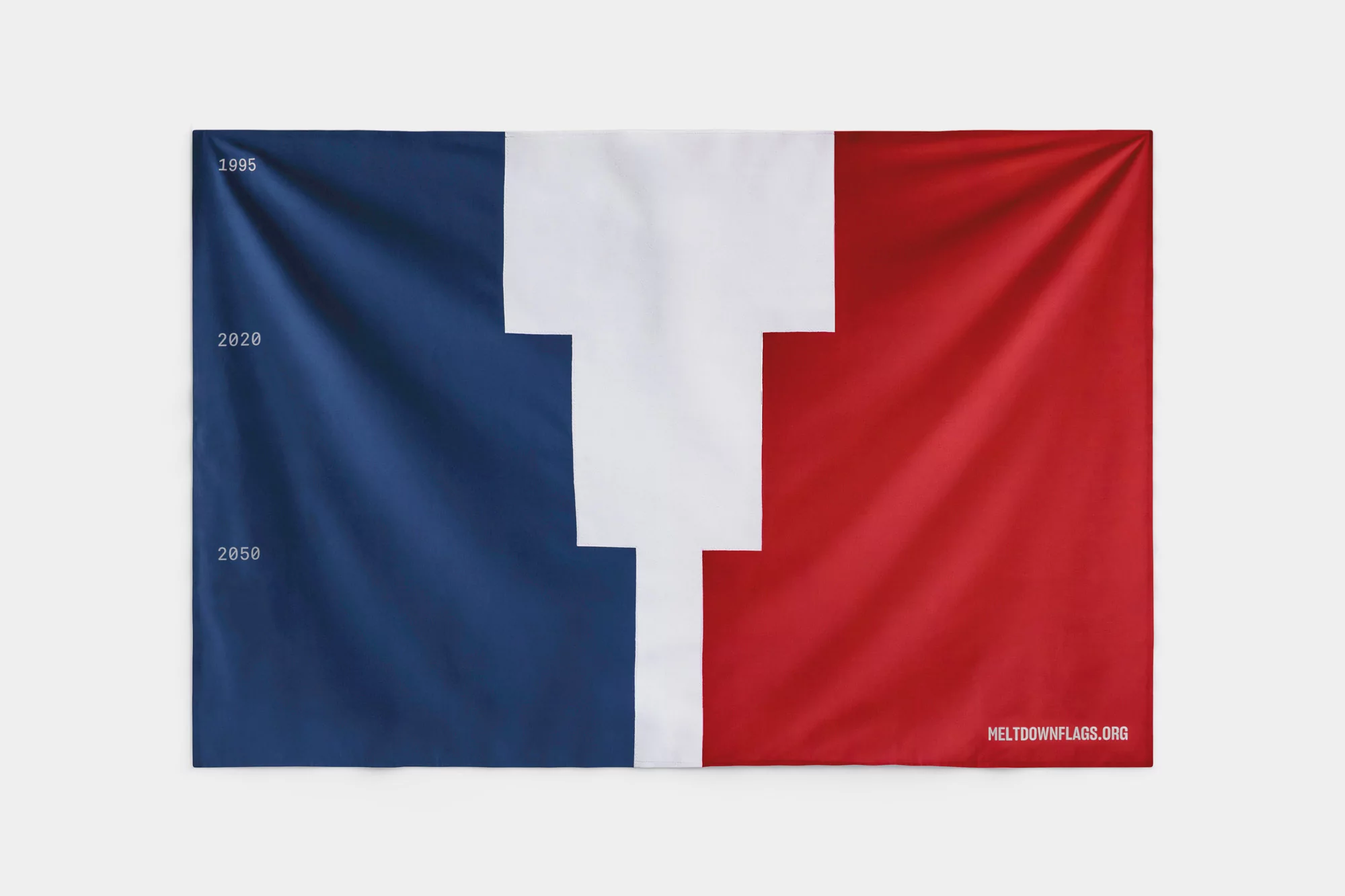 Striking fabric banner featuring a unique three-color design in blue, white, and red, with the URL meltdownflags.org printed in the lower right.