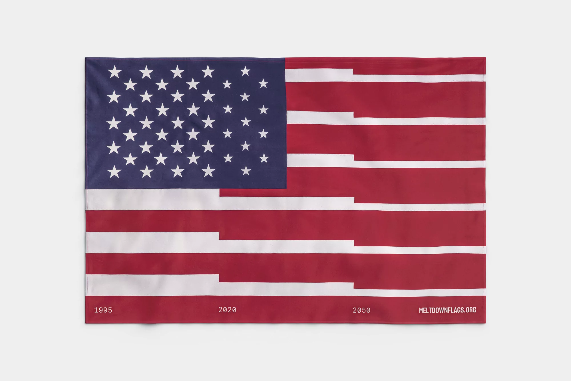 An artistic representation of the American flag features partially erased stripes and is set against a plain white background.