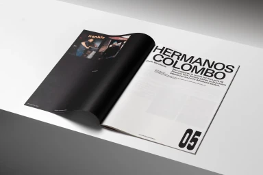 An open magazine layout featuring bold typography and two small portrait photographs on a plain white surface.