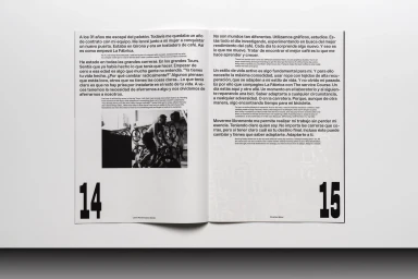 Open magazine spread featuring columns of bilingual text, large page numbers 14 and 15, and a small black and white photograph of a cyclist.