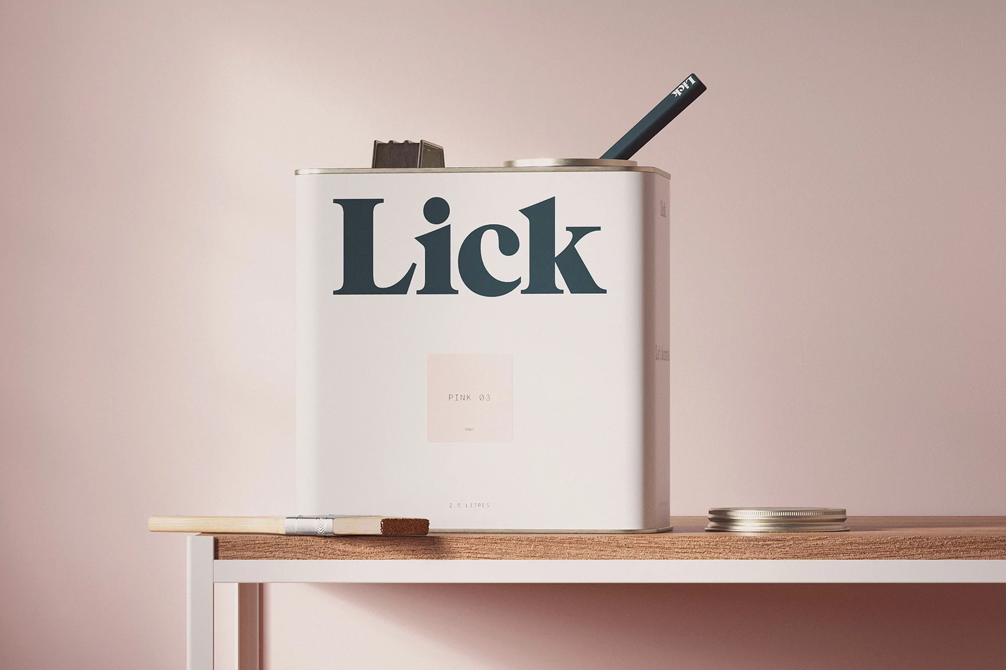 Close-up shot of a 'Lick' brand white paint can with a paintbrush and stirrer, positioned on a light wooden shelf against a pink background.