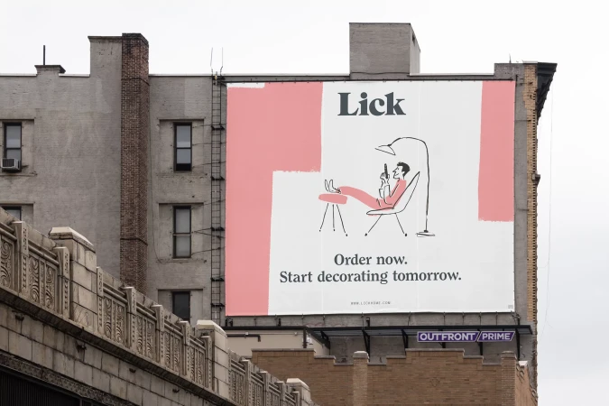 Illustrated advertisement for Lick home decor featuring a man in a chair, set on a billboard attached to a brick building.