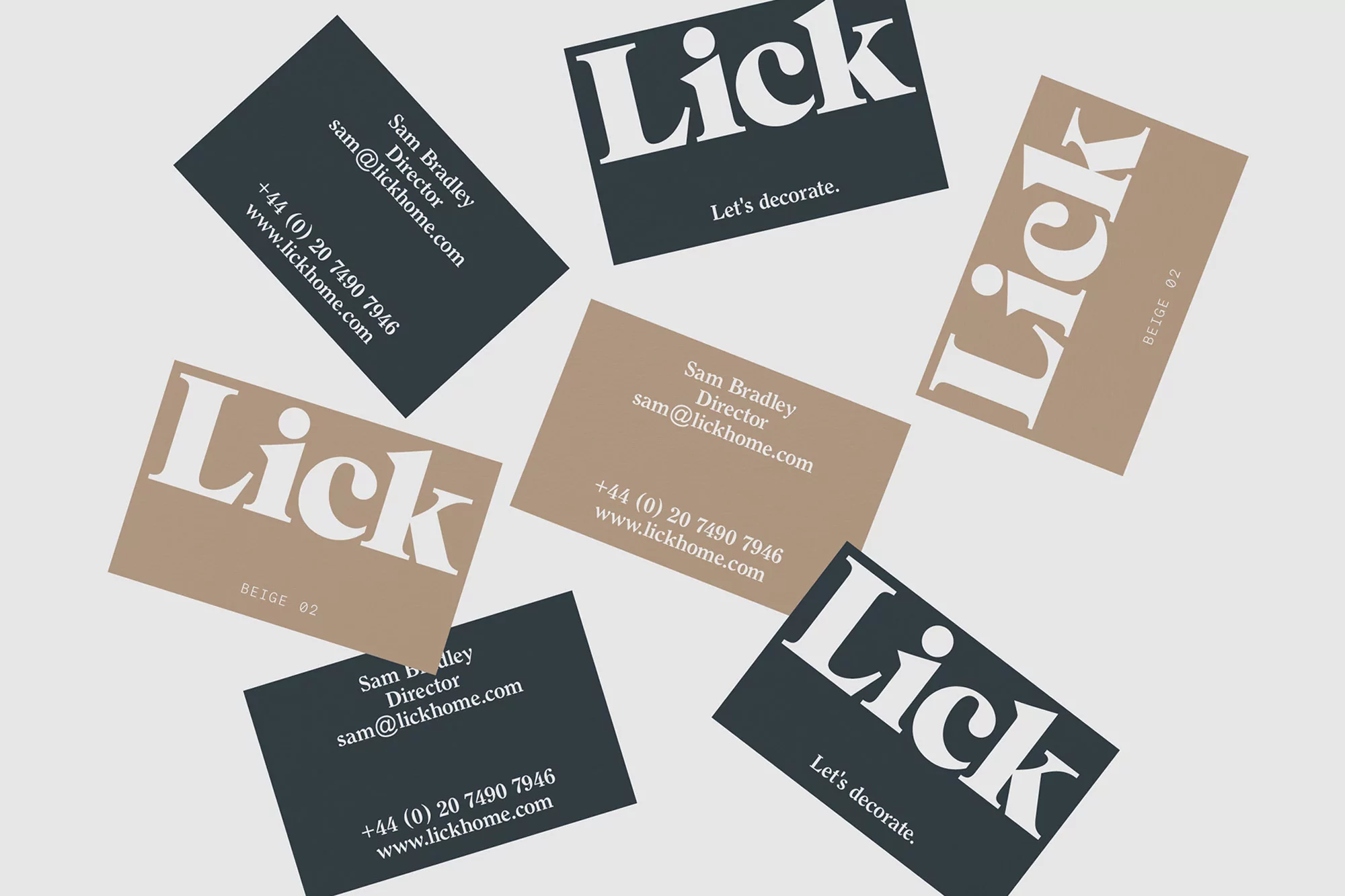 Arrangement of tan and dark gray business cards with the logo Lick and contact information on a light gray background.