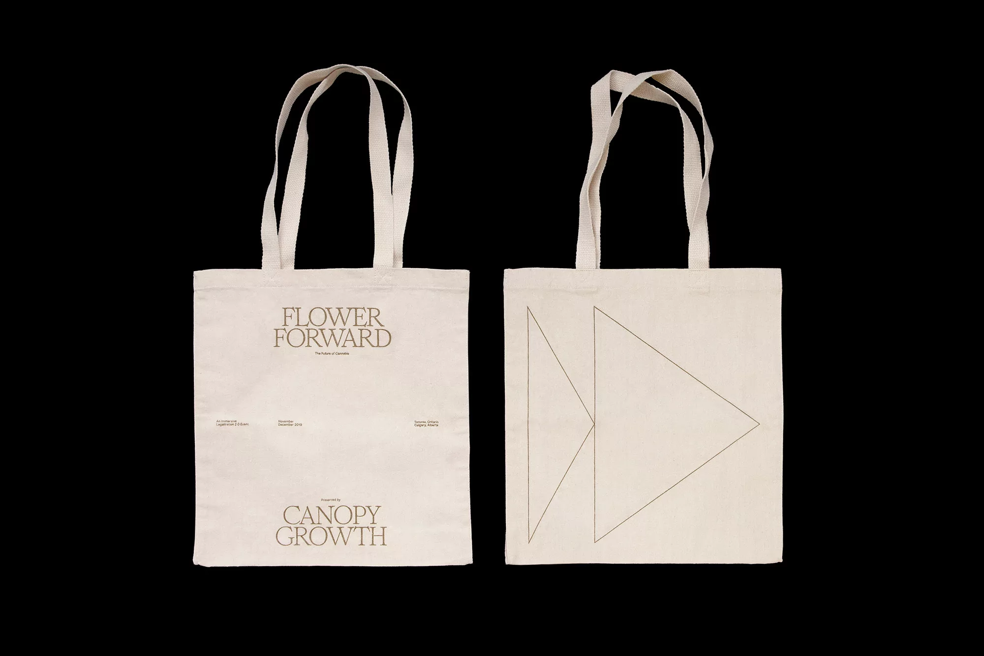 Two ecru canvas tote bags with geometric and text designs. Sustainable fashion, eco-friendly shopping, and promotional merchandise visuals.