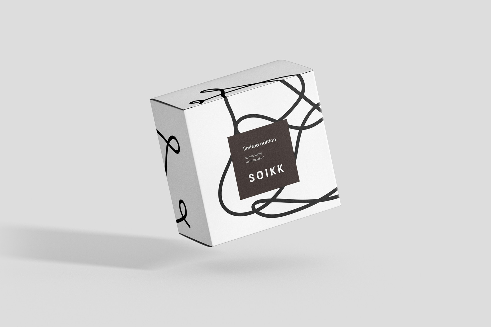 Studio shot of a floating, white, rectangular product box with a minimalist black line art pattern and a small product label.