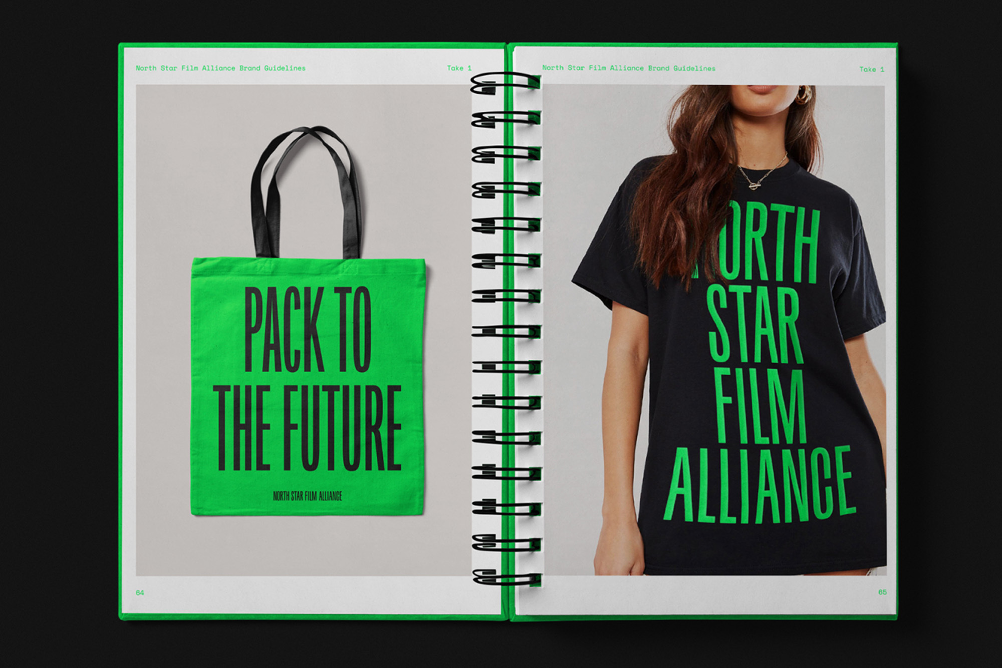 An open magazine displays a green tote bag and a woman wearing a black T-shirt, both featuring brand-related text on a white page.