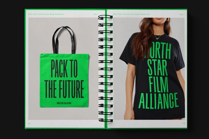 Open spiral-bound brand guidelines book showcasing a bright green tote bag and a person wearing a black t-shirt with large typography.