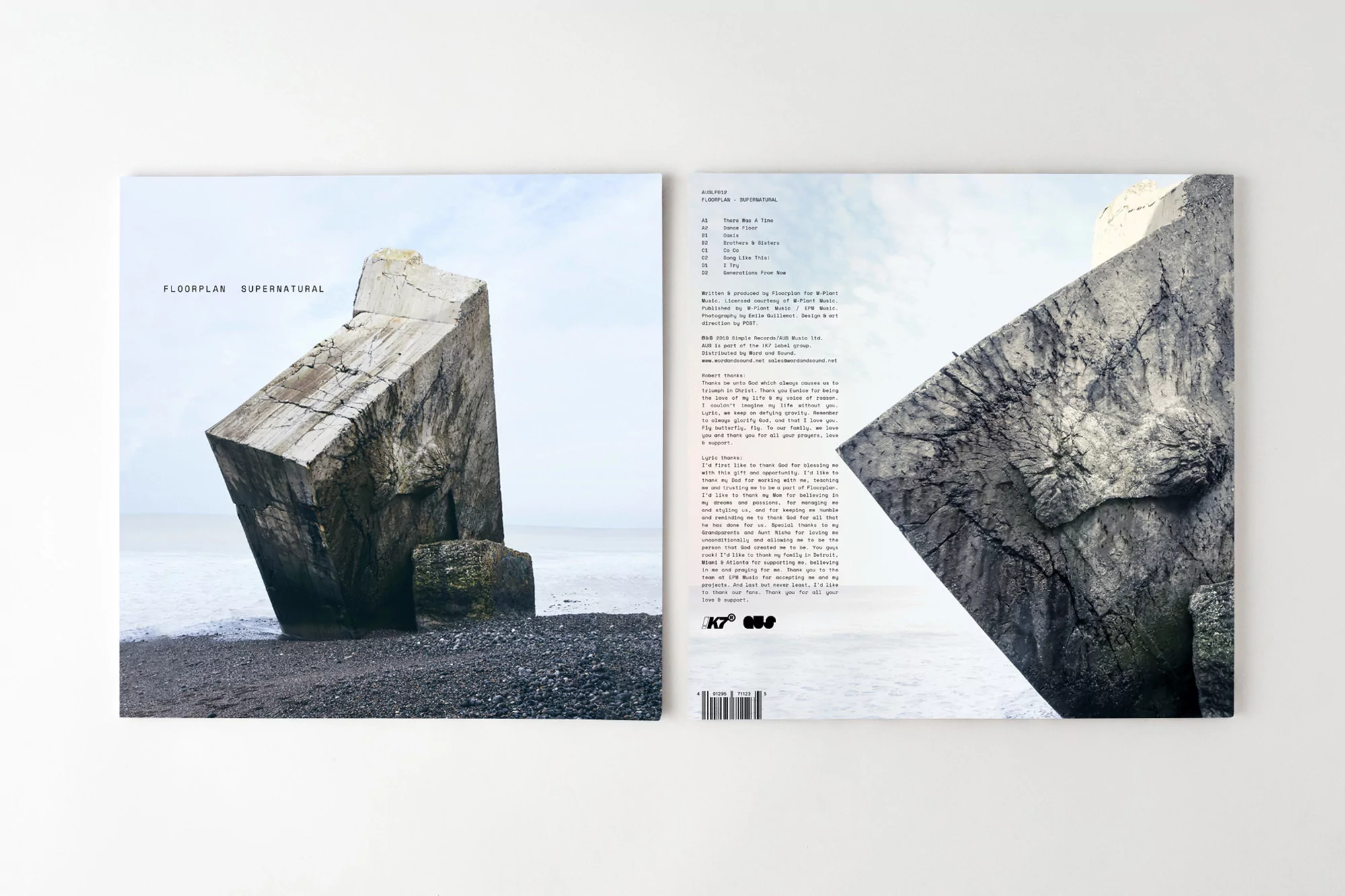Album cover featuring a concrete block on a rocky beach under a light sky, alongside the tracklist and album information.