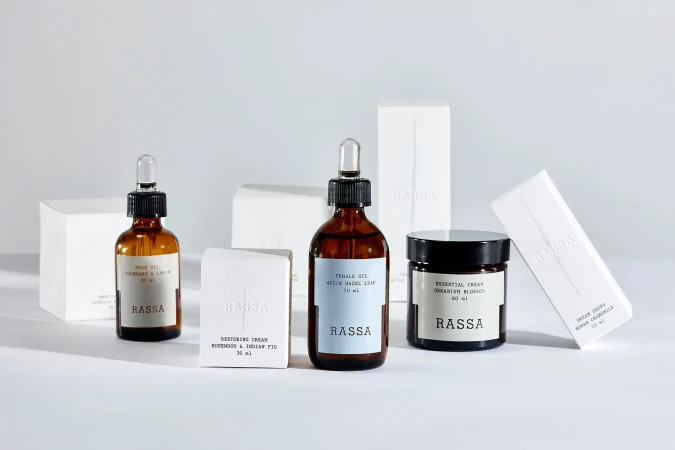 Assortment of Rassa skincare products displayed in dropper bottles and cream jars, neatly arranged against a clean, white background.