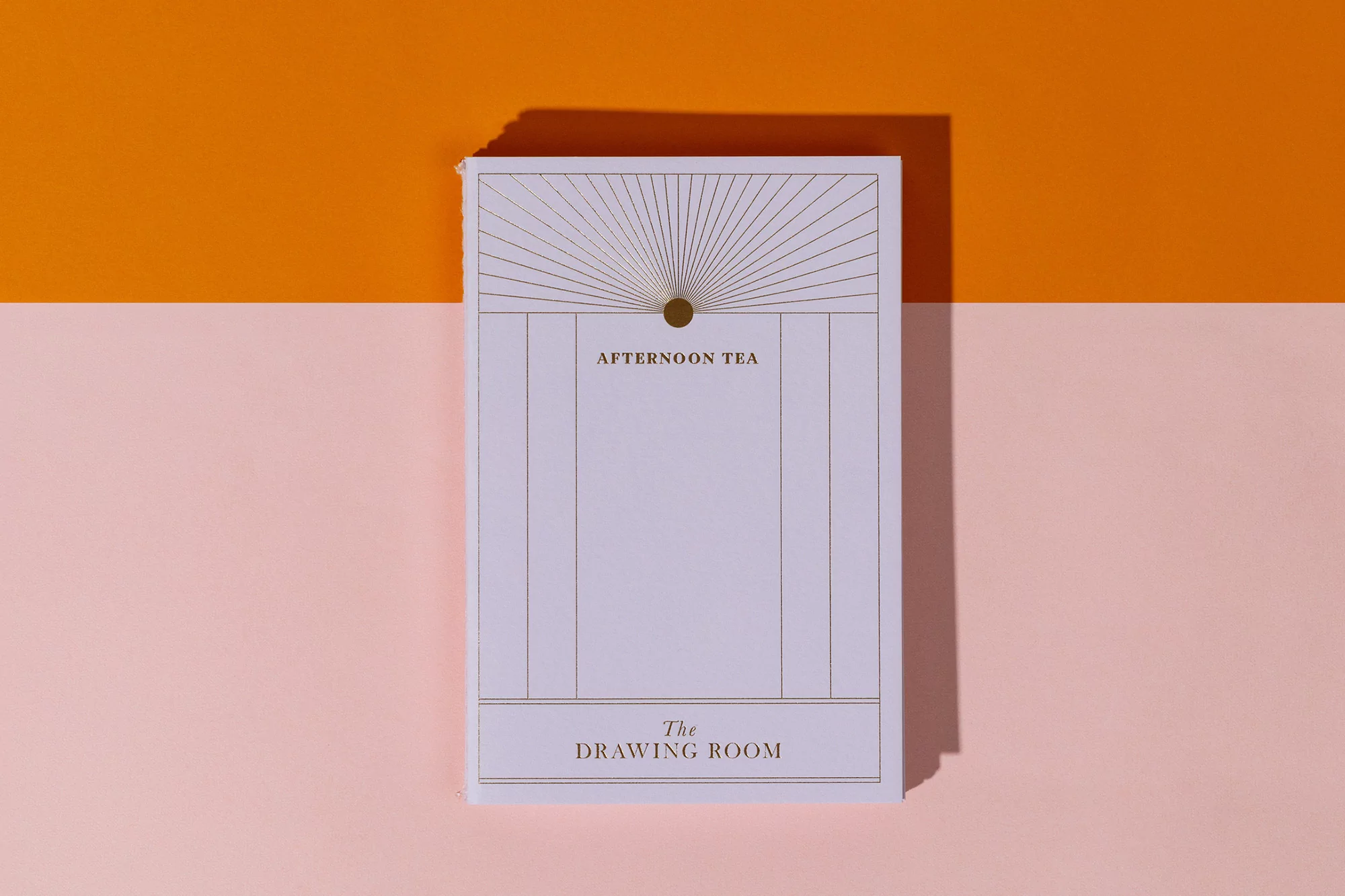 Graphic design menu featuring 'Afternoon Tea' and 'The Drawing Room' with geometric sunburst design on an orange and pink backdrop.