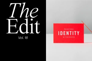 Split view with bold white serif text on a black panel and a vibrant red business card on a neutral surface