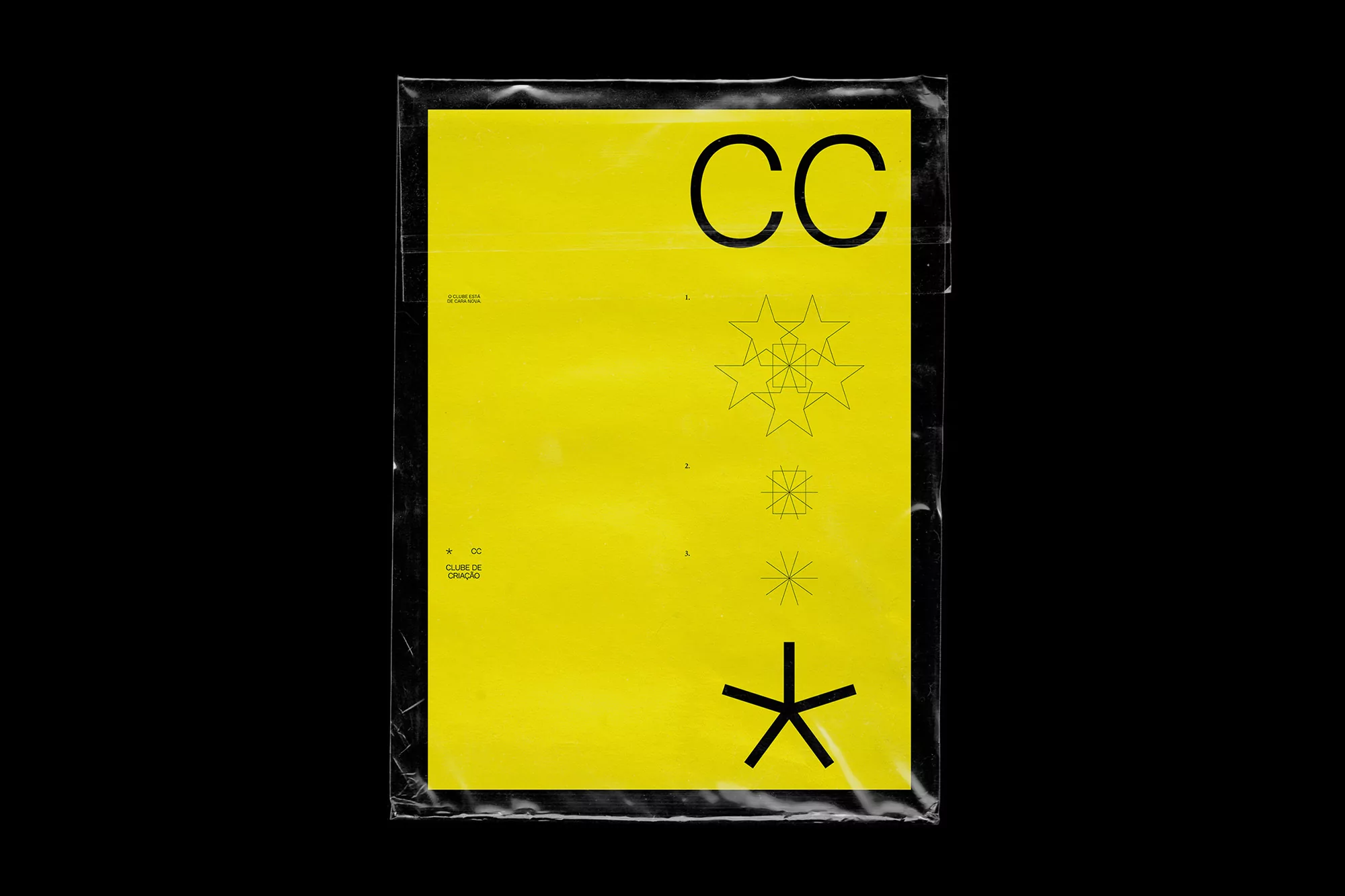 Graphic design poster in a plastic sleeve featuring a yellow background with abstract geometric shapes and black sans-serif typography.
