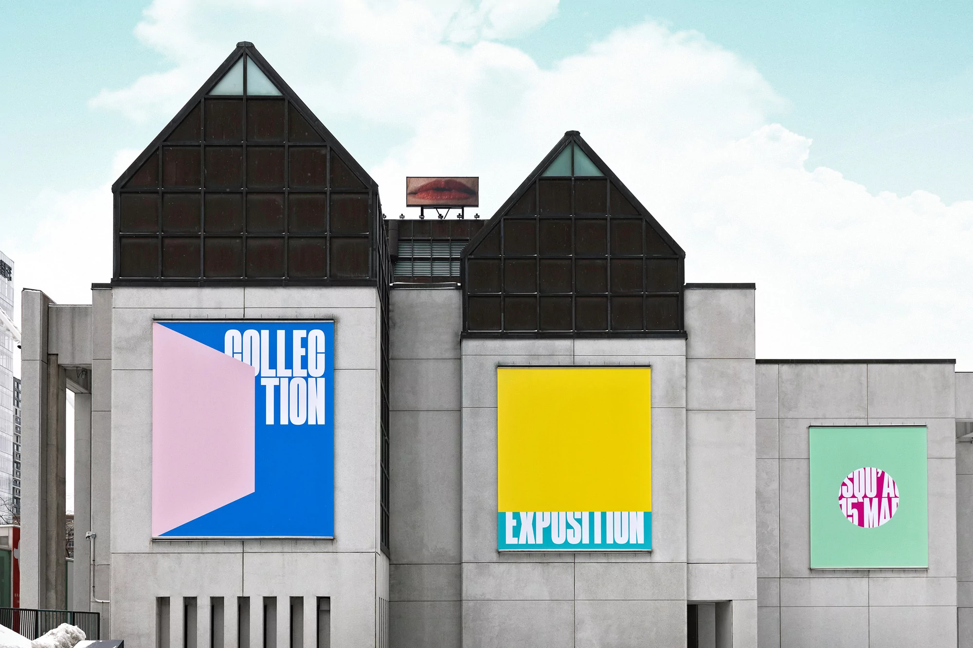 Modern concrete building featuring colorful art posters for 'Collection' and 'Exposition' under a partly cloudy sky.