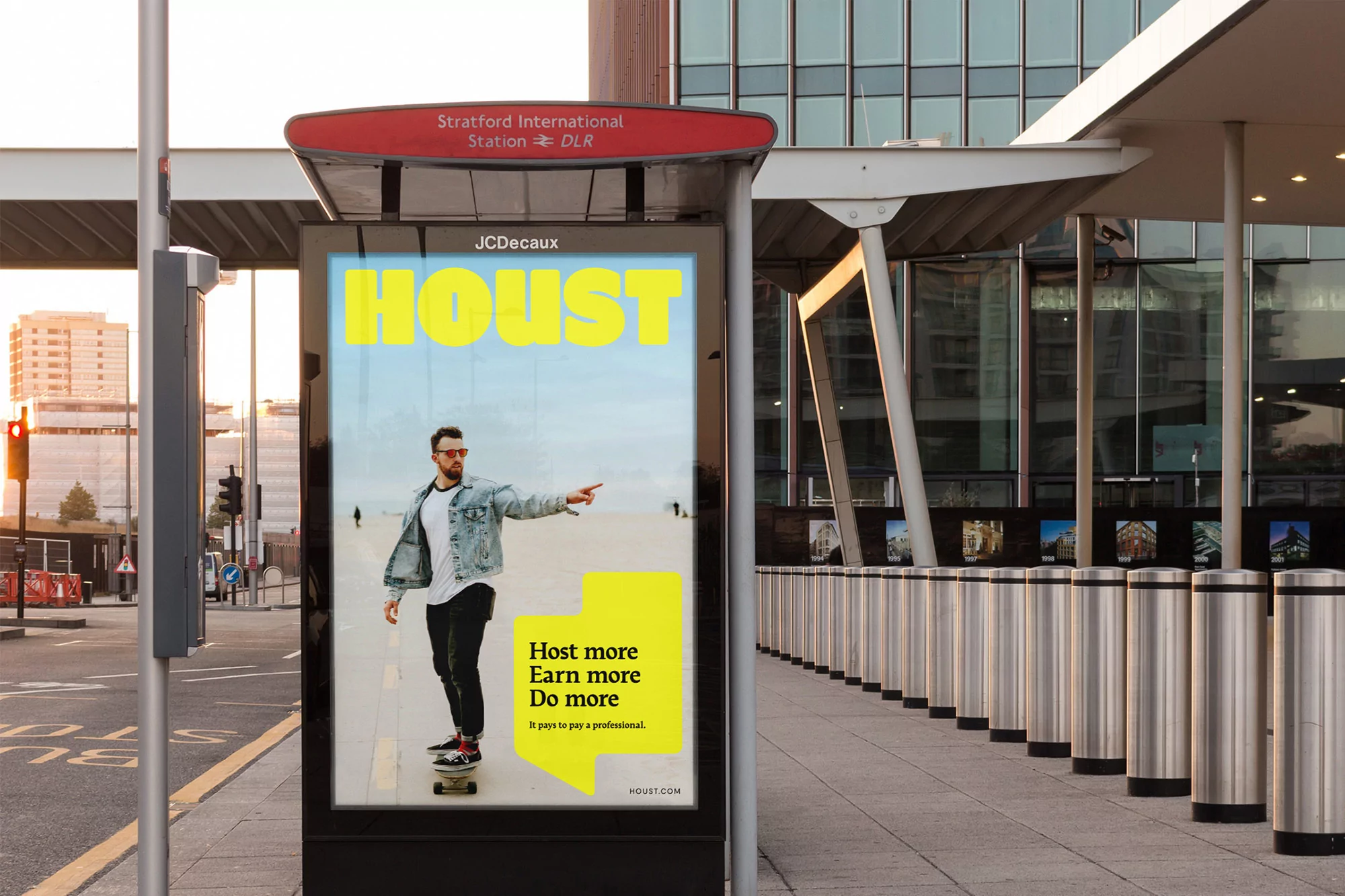 Outdoor advertising featuring a man on a skateboard pointing. The ad also includes text reading, "Host more. Earn more. Do more."