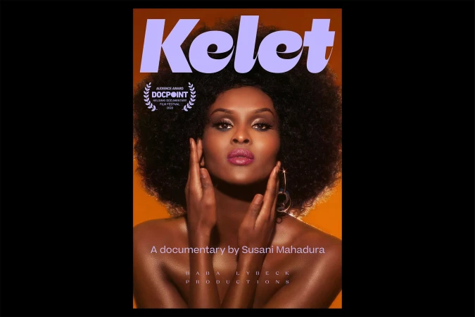 A magazine cover featuring a portrait of an African American woman with dark hair, large hoop earrings and orange background.