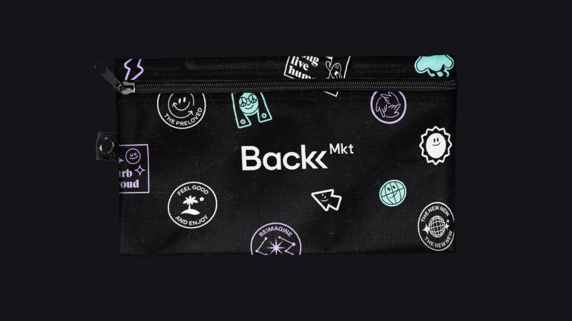 Black zipper pouch with assorted icons and text graphics, product branding, and minimalist design against a dark background.