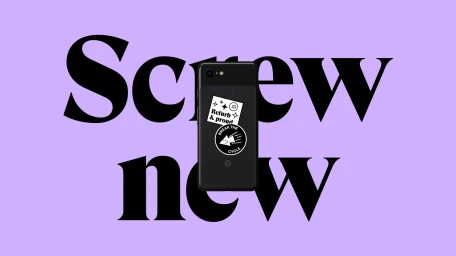 A black smartphone with stickers on a solid purple background featuring bold typography that reads Screw new
