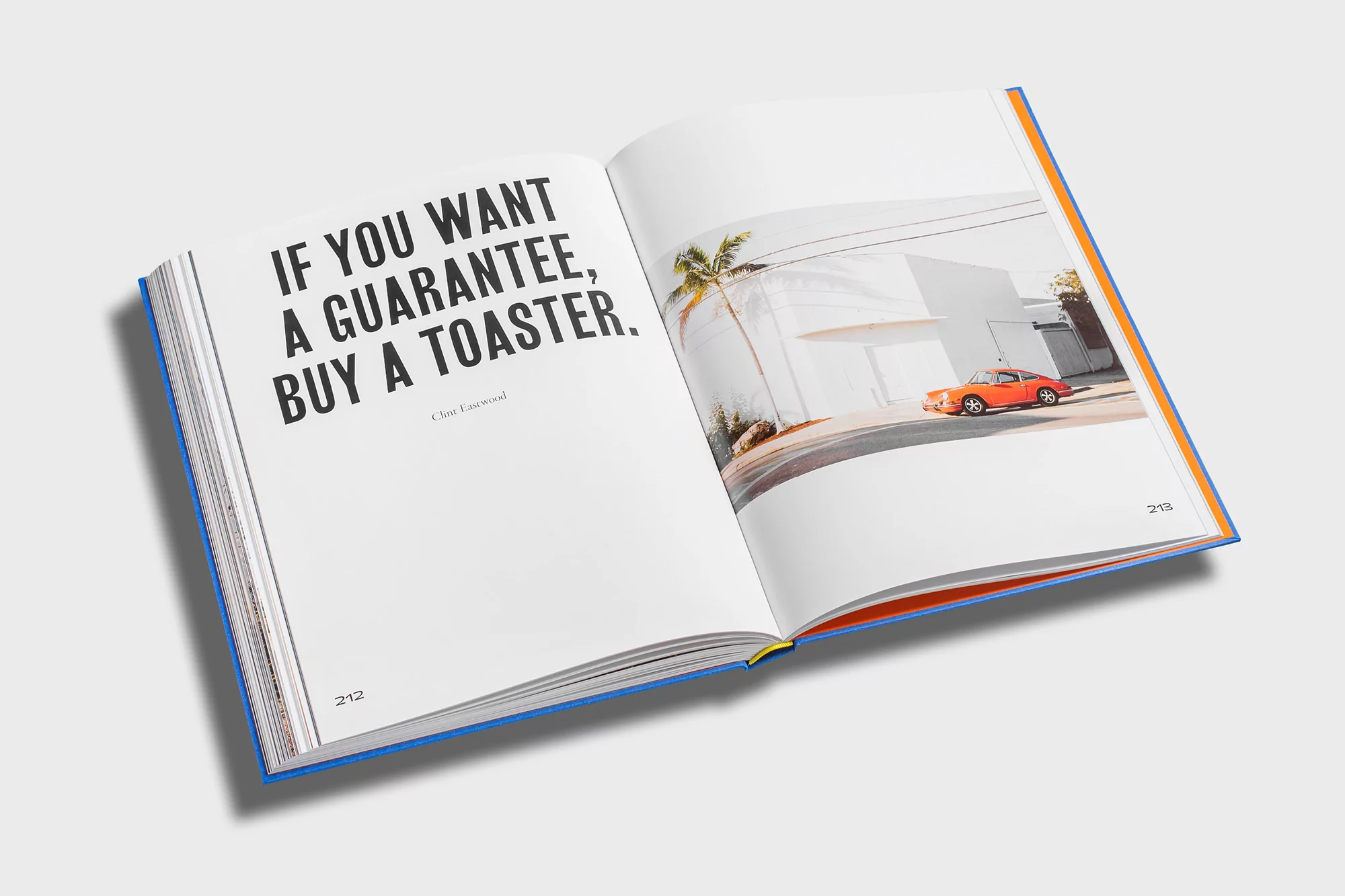 Open book displaying a quote about toasters on the left page and a vivid photograph of a car beside a building on the right page.
