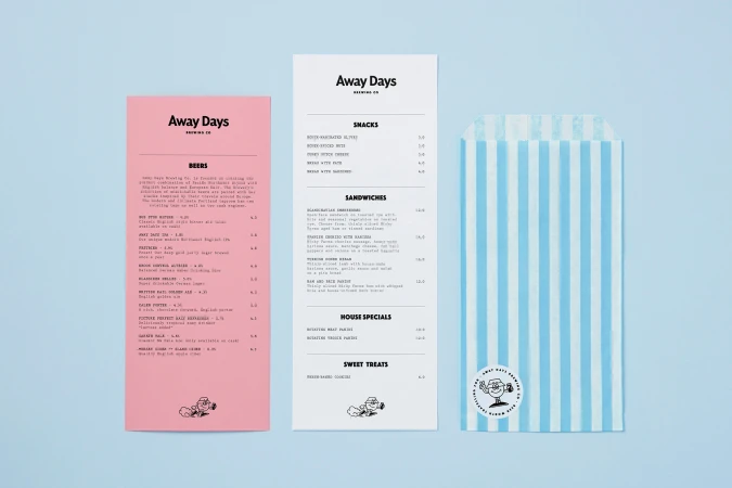 Promotional image for Away Days Brewing Co. featuring a pink menu, a white menu, and a blue-and-white striped bag on blue background.