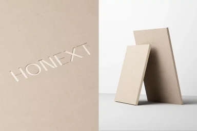 Embossed Honext brand logo on a textured panel beside two rectangular beige slabs on a white surface