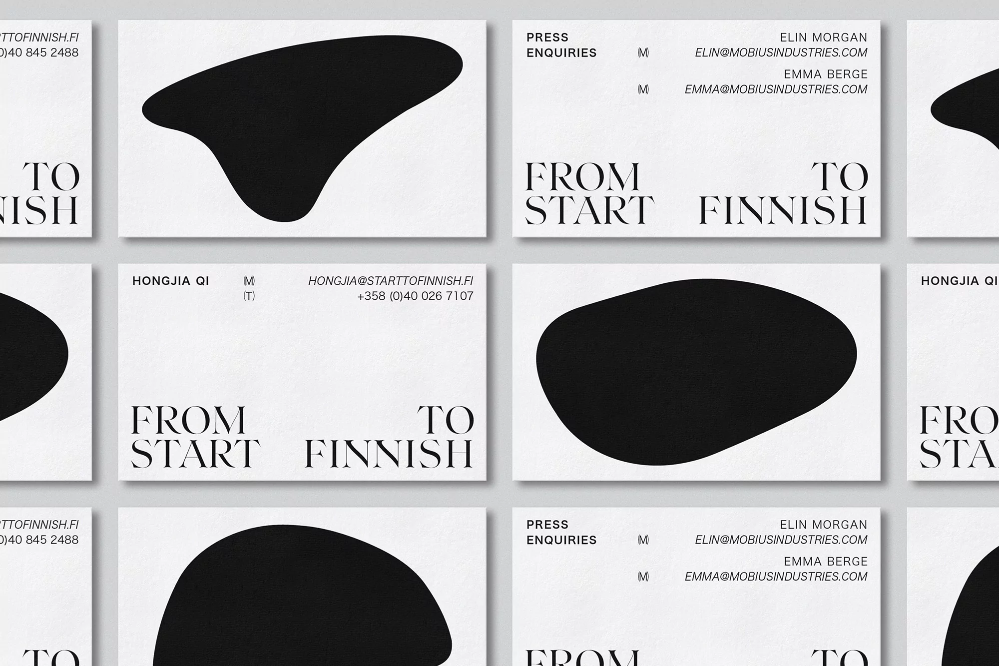 Modern business cards with sleek black shapes and minimalist typography reading 'From Start To Finnish', showcasing a clean, corporate design.
