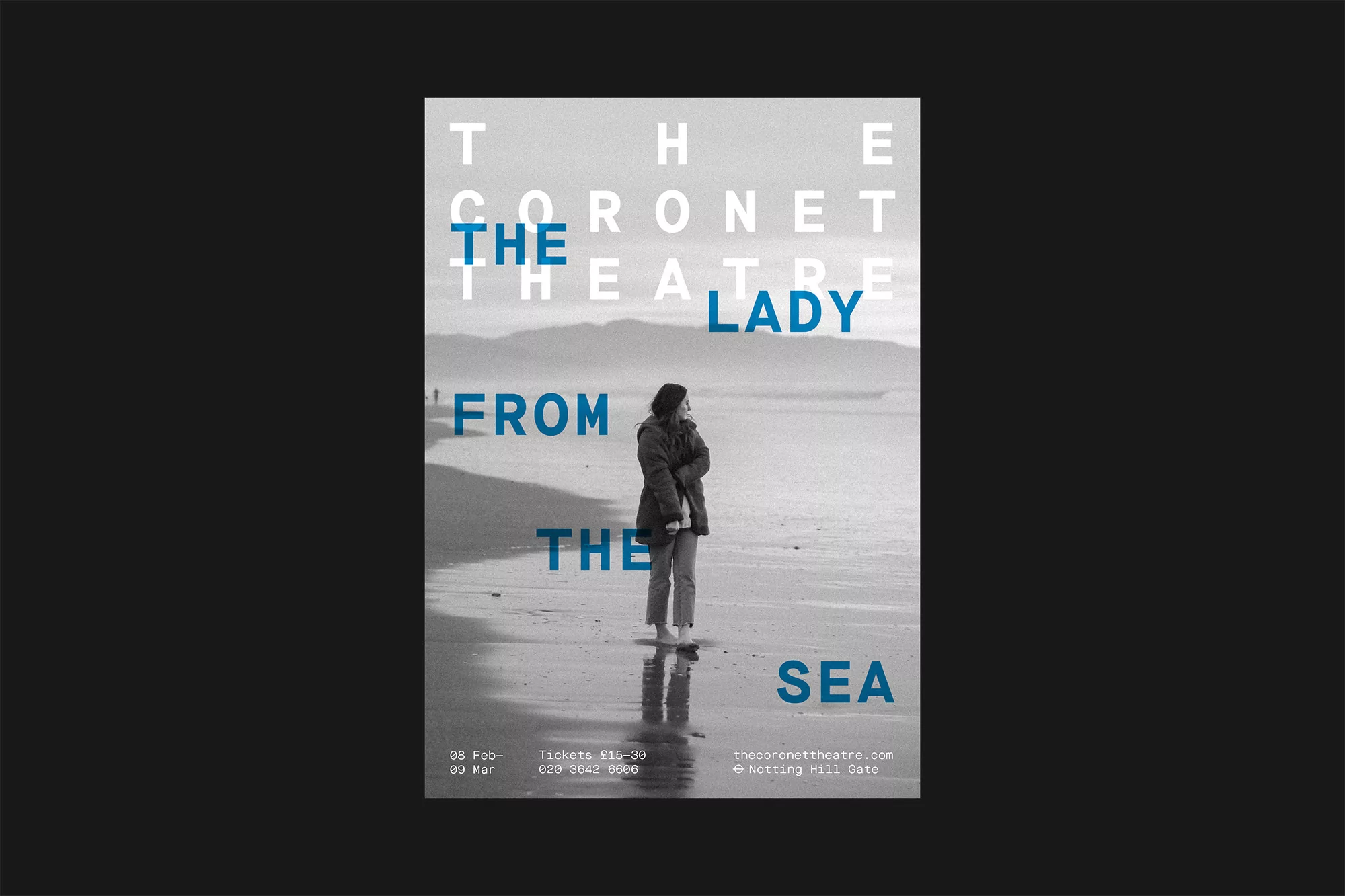 Theatre poster with a black and white image of a person on a wet beach, layered with bold blue and white typography.