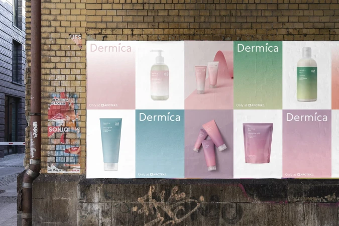Outdoor advertisement featuring Dermíca skincare products displayed on a weathered brick wall in an urban setting, promoting beauty and skincare.