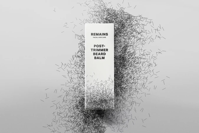 White beard balm bottle by Remains with text 'Remains Facial Hair Care' surrounded by a graphic of black beard trimmings.