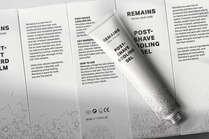 White tube of Remains post-shave cooling gel placed diagonally across branded packaging panels.
