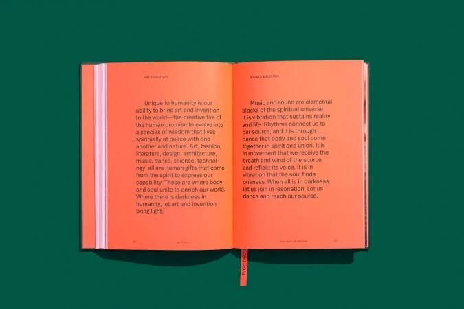 Open book displays text on creativity and sound reflection. Orange pages contrast with a dark green backdrop. Bookmark.