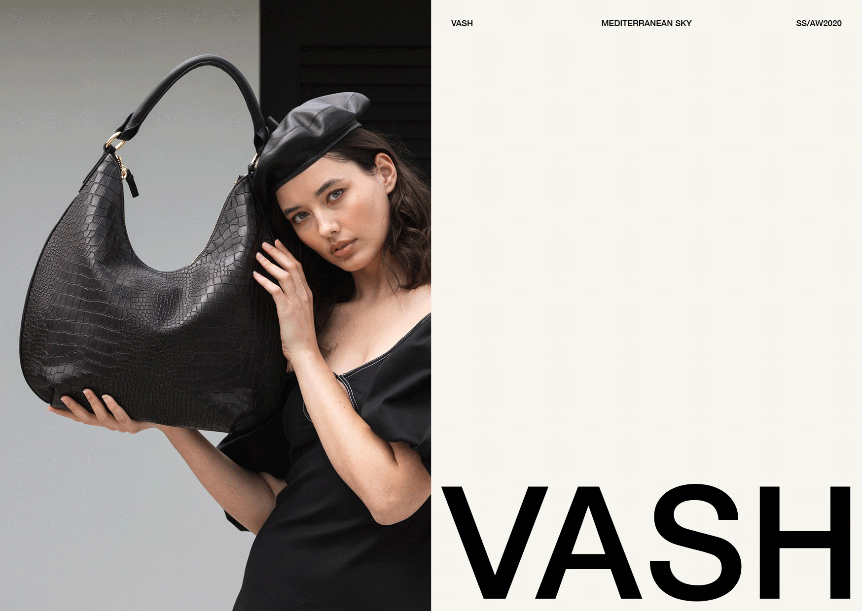 Fashion shot of a woman with a black beret and dress holding a large black faux crocodile leather hobo bag on a split grey/white background.