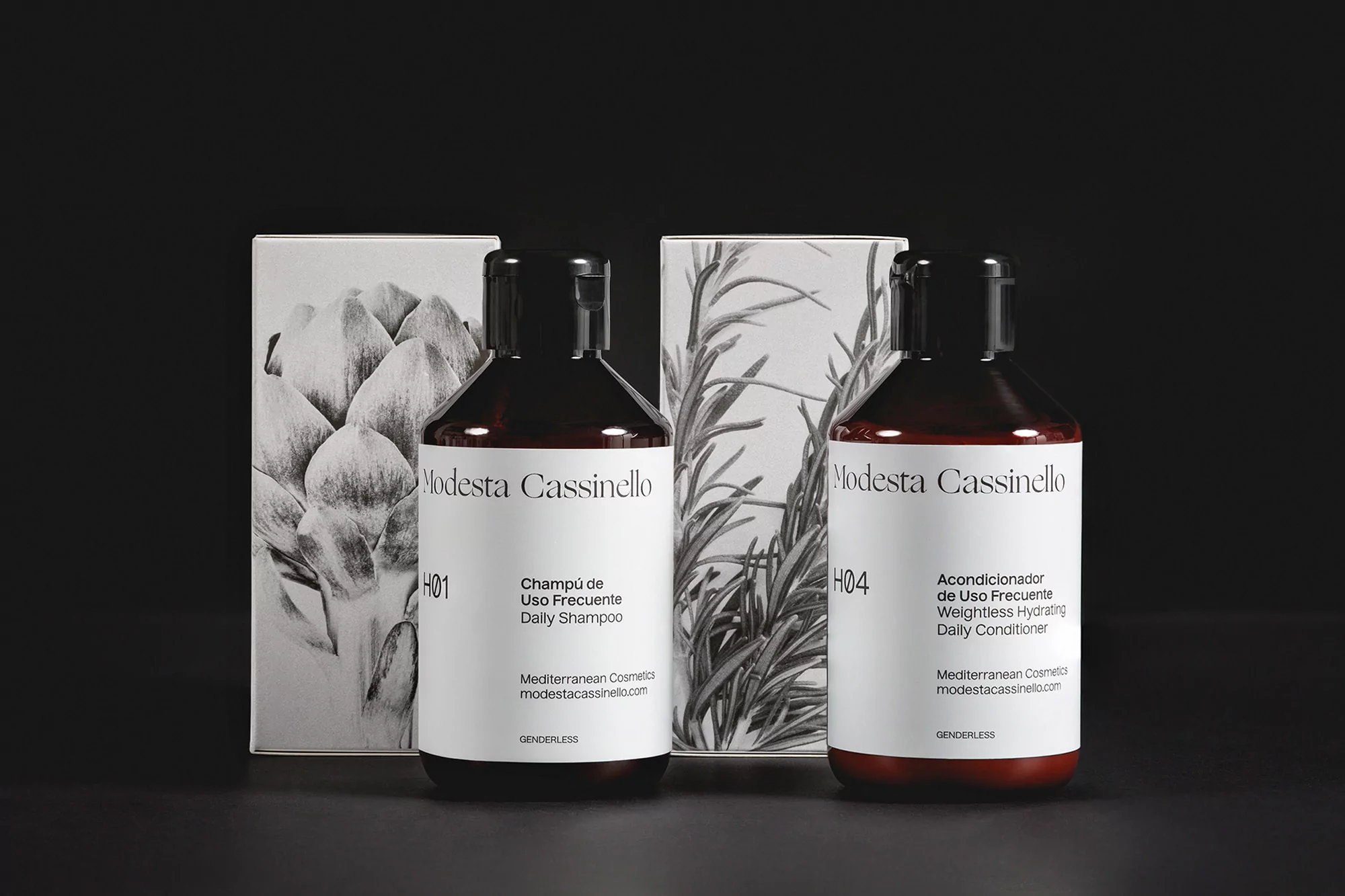 Two dark amber bottles of Modesta Cassinello shampoo and conditioner are set against a minimalist black backdrop with botanical-themed packaging.