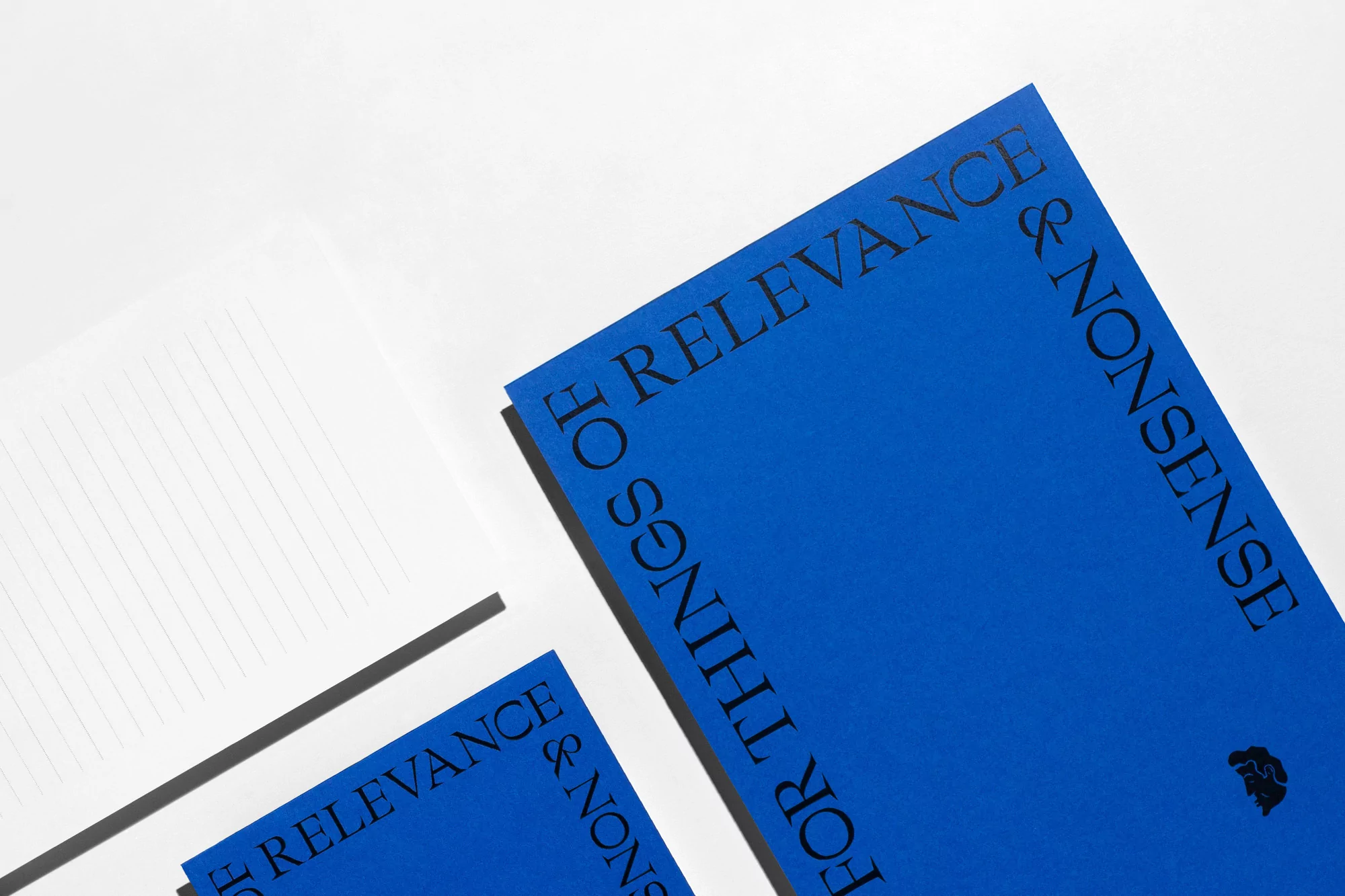 Three notebooks with blue covers and black text lie on a white background, arranged at angles, creating a minimalist book mockup.