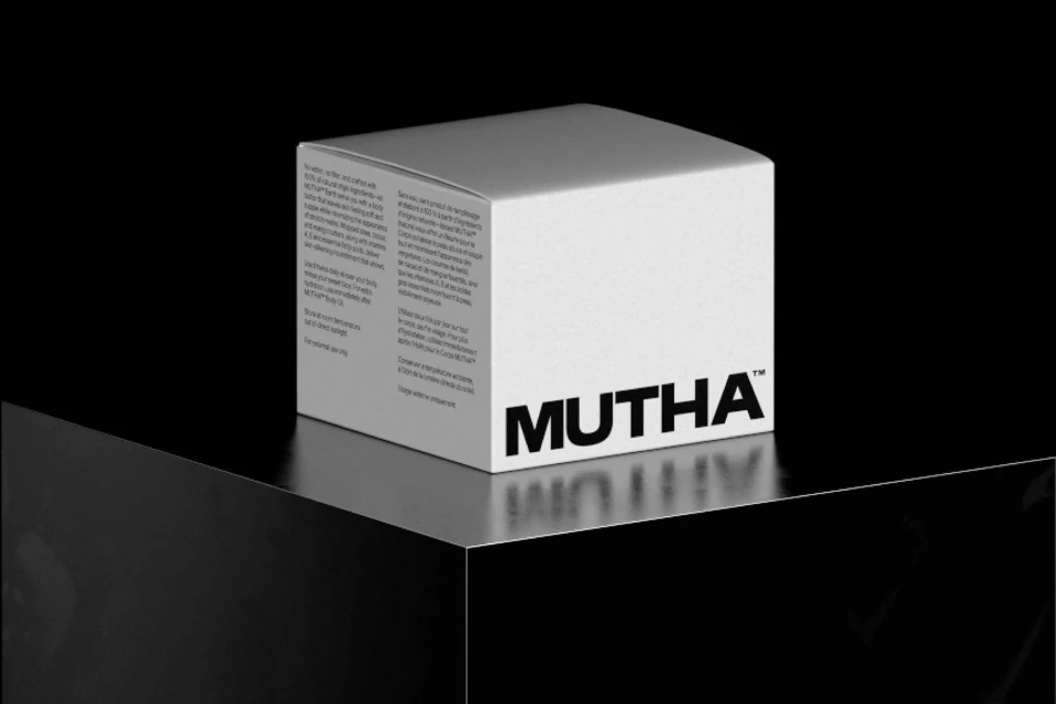White box with product information and the brand name 'MUTHA' against a black background, product photography, packaging design.